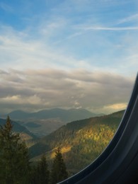 Image of Airplane taking off or landing, view on mountains from window