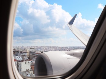 Airplane taking off or landing, view on city from window