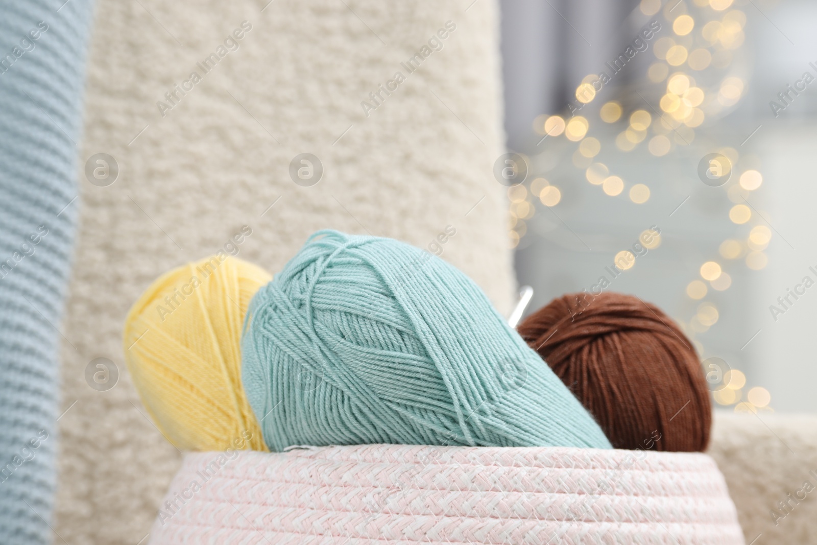 Photo of Knitting material. Skeins of soft yarn indoors, closeup