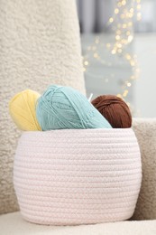 Photo of Knitting material. Skeins of soft yarn on armchair