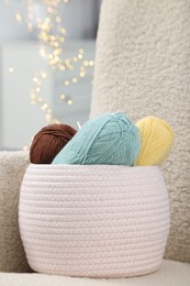 Photo of Knitting material. Skeins of soft yarn on armchair