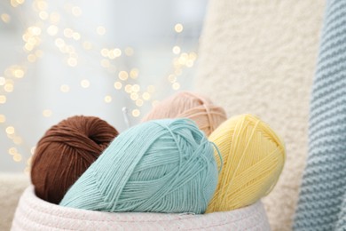 Photo of Knitting material. Skeins of soft yarn indoors, closeup