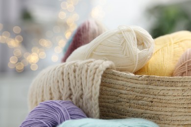 Photo of Skeins of yarn and knitting sample indoors, closeup