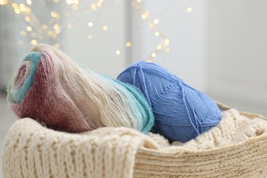 Skeins of yarn and knitting sample indoors, closeup