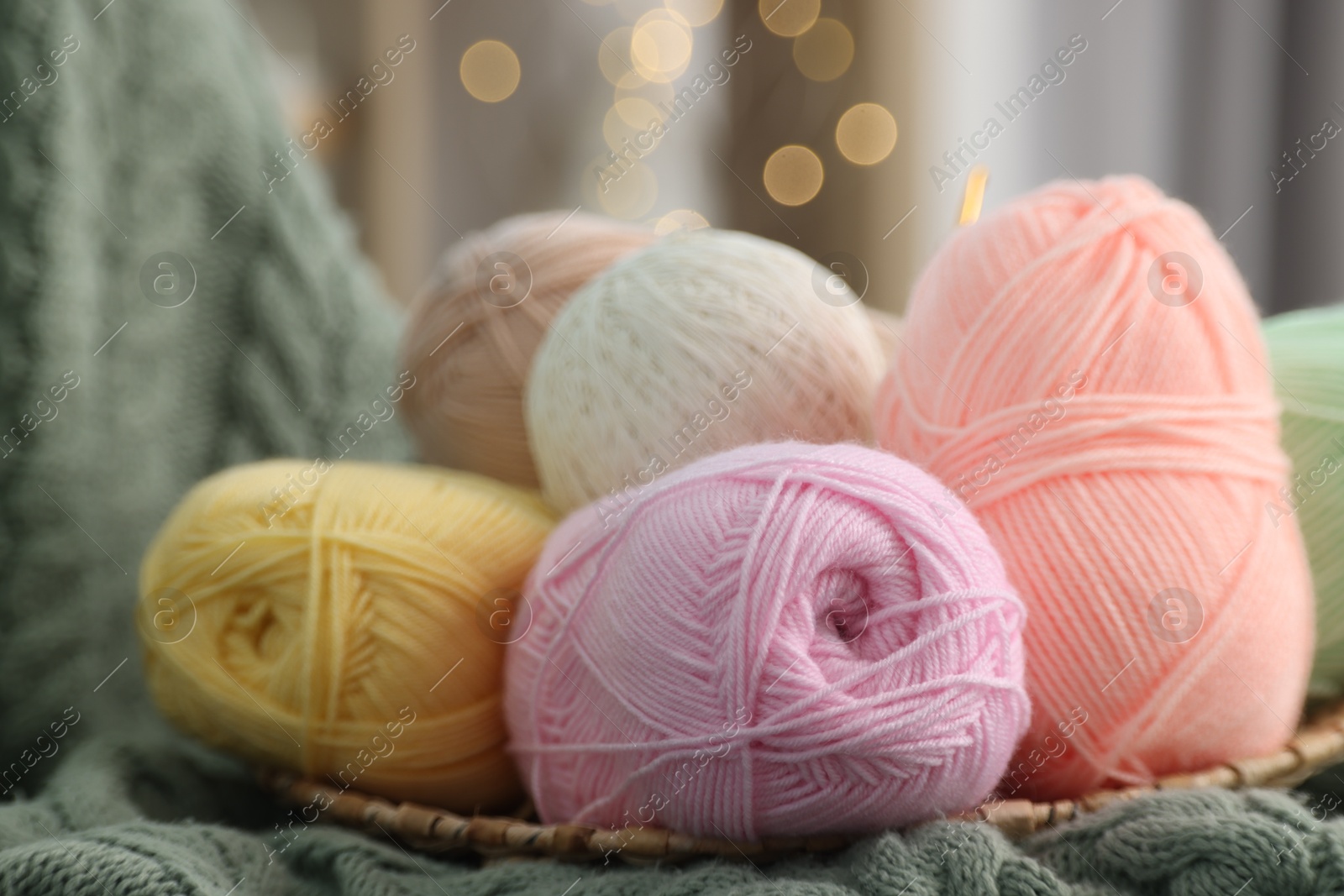 Photo of Knitting material. Skeins of soft yarn on plaid, closeup