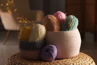 Knitting material. Skeins of soft yarn and crochet hooks on table indoors