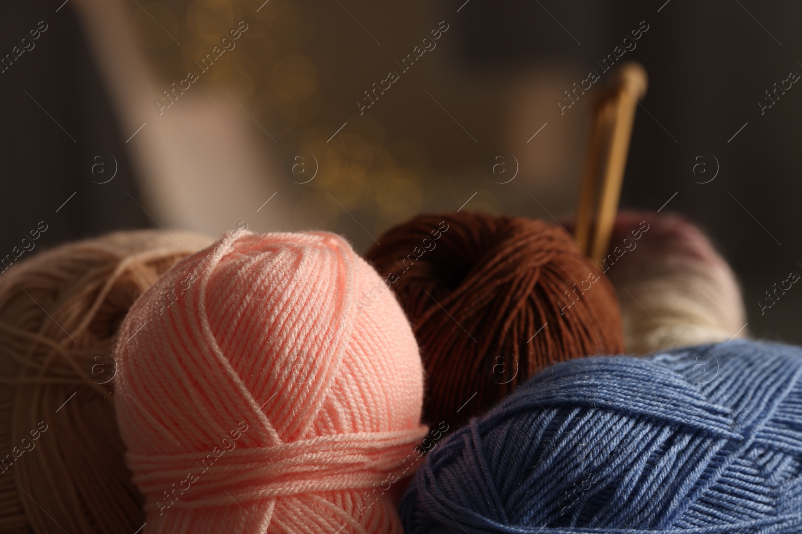 Photo of Knitting material. Skeins of soft yarn against blurred background, closeup