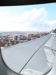 Airplane taking off or landing, view on city from window