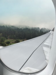 Image of Airplane taking off or landing, view on mountains from window