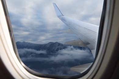 Airplane flying over mountains, beautiful view from window