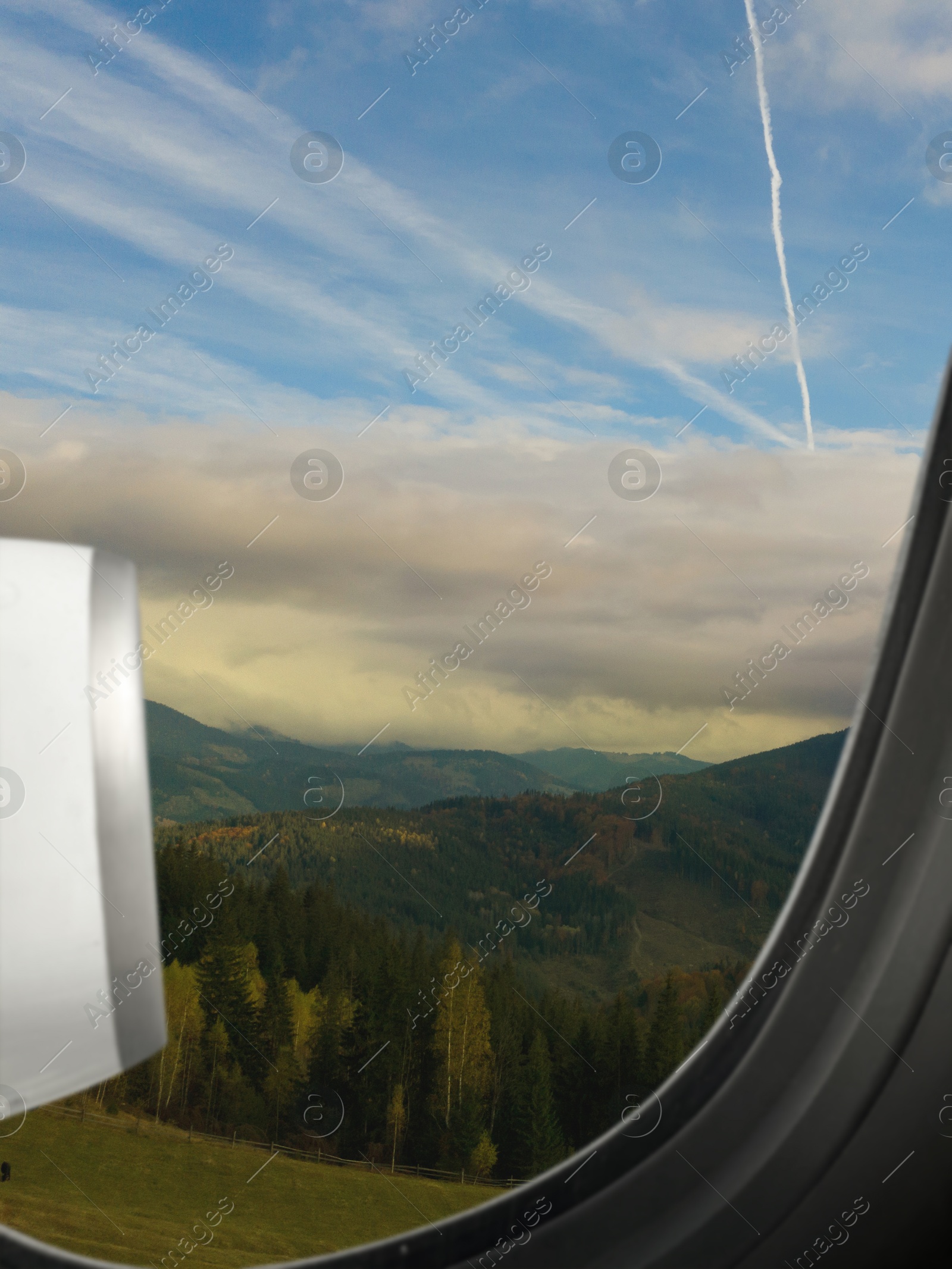 Image of Airplane taking off or landing, view on mountains from window