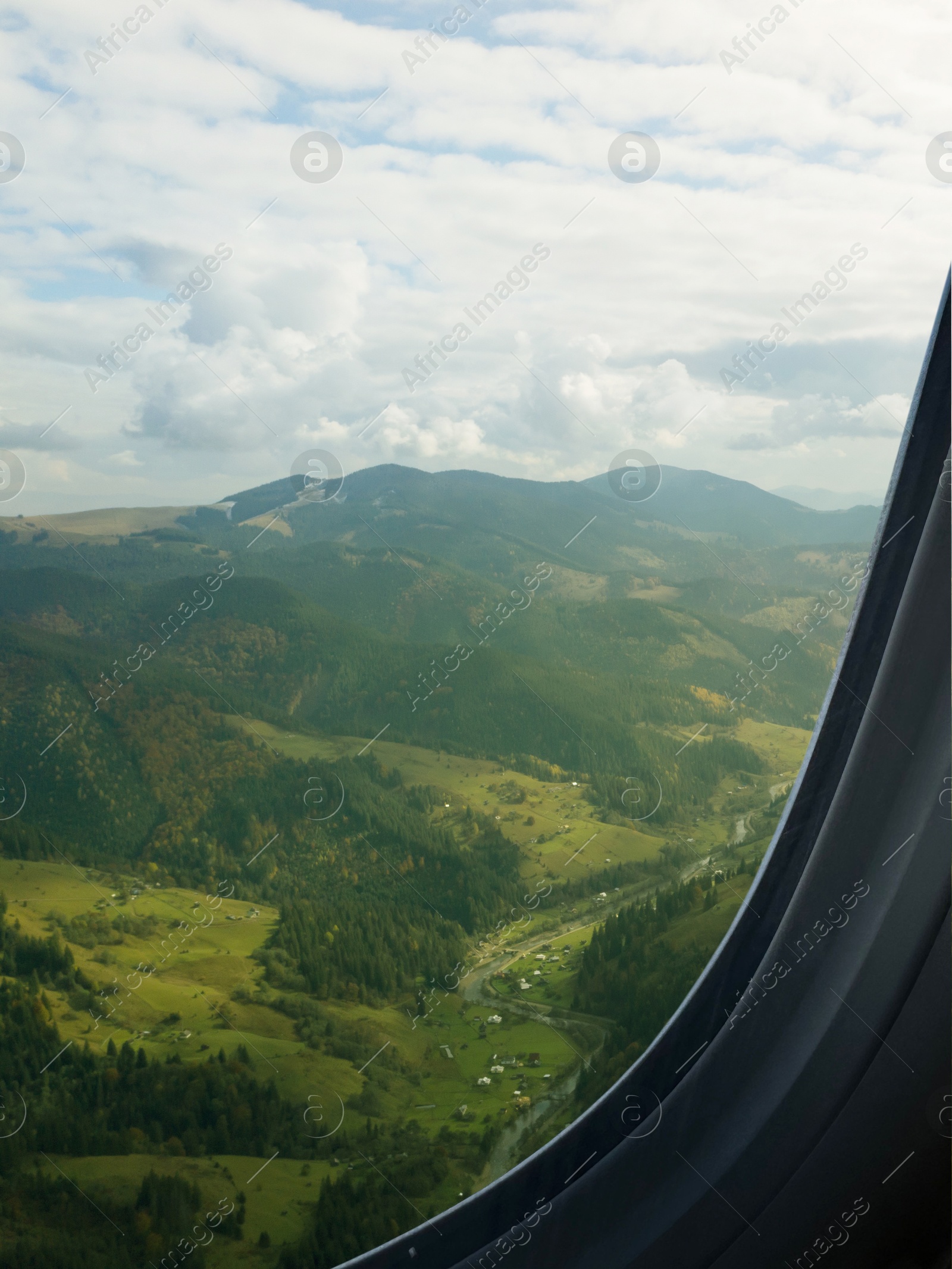 Image of Airplane flying over mountains, beautiful view from window