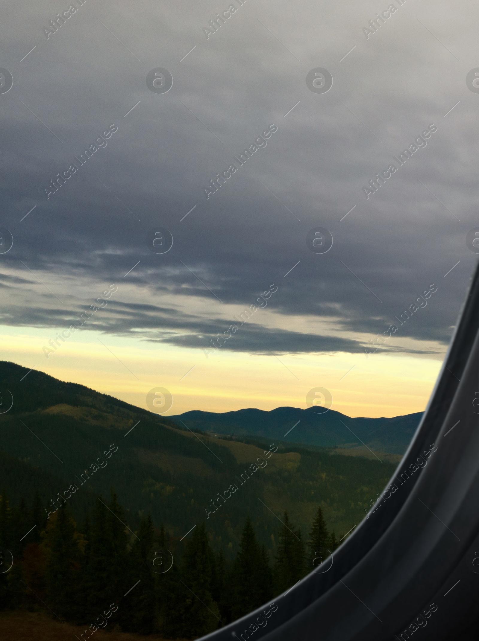 Image of Airplane taking off or landing, view on mountains from window