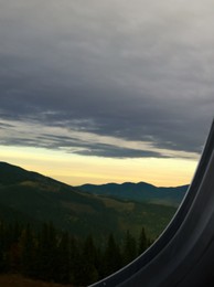 Image of Airplane taking off or landing, view on mountains from window