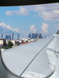 Image of Airplane taking off or landing, view on city from window