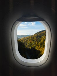 Airplane flying over mountains, beautiful view from window