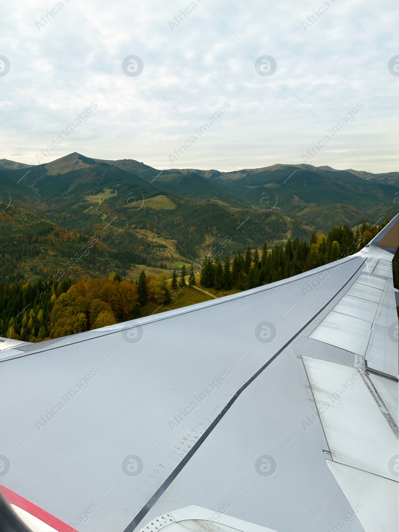 Image of Airplane taking off or landing, view on mountains from window