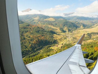 Airplane flying over mountains, beautiful view from window