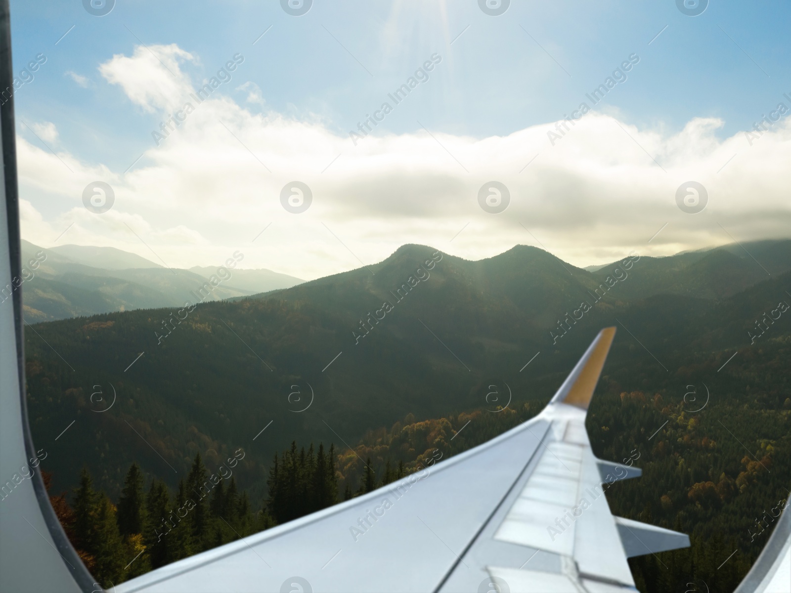 Image of Airplane taking off or landing, view on mountains from window