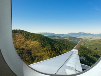 Airplane flying over mountains, beautiful view from window