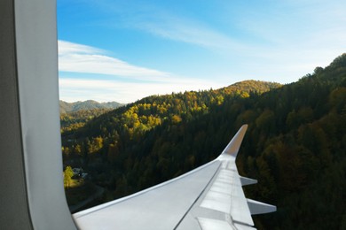 Airplane taking off or landing, view on mountains from window