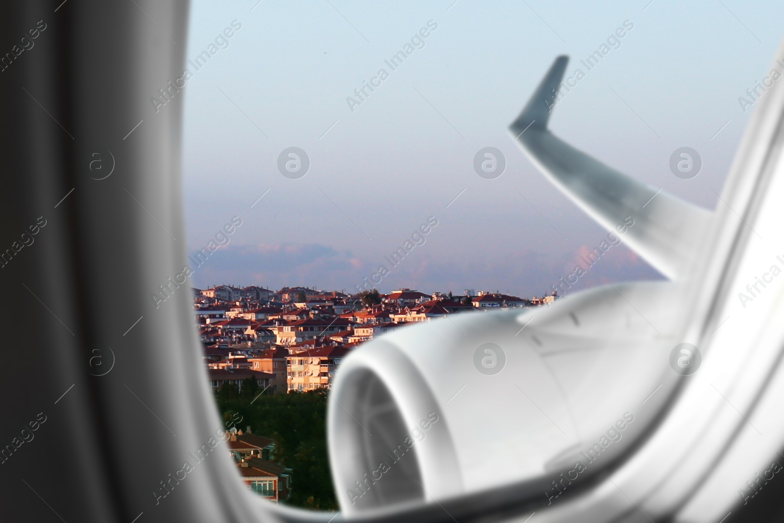 Image of Airplane taking off or landing, view on city from window