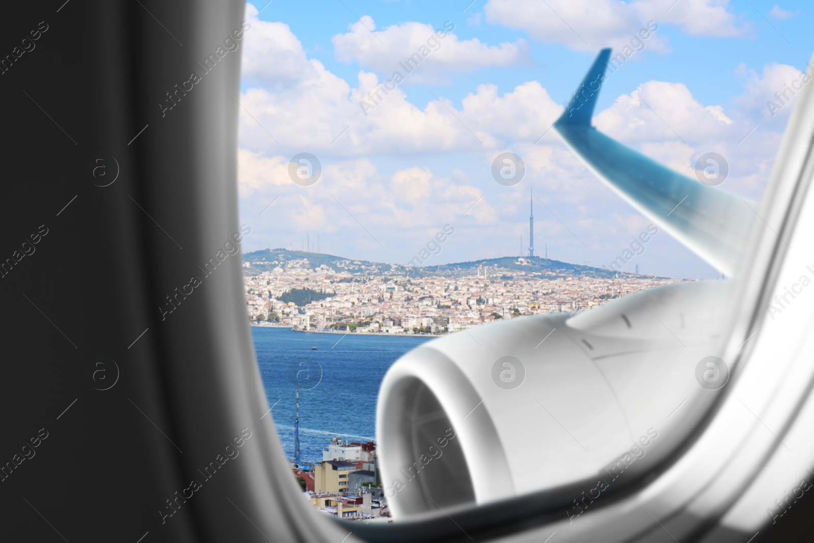 Image of Airplane taking off or landing, view on city from window