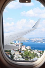 Airplane taking off or landing, view on city from window