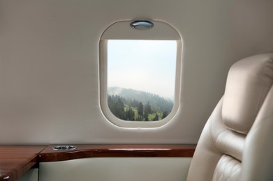 Image of Airplane taking off or landing, view on mountains from window