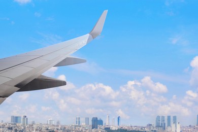 Image of Airplane taking off or landing, view on city from window