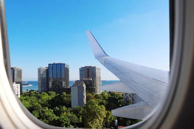 Image of Airplane taking off or landing, view on city from window