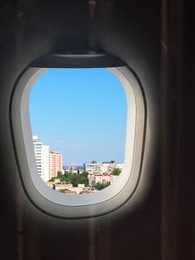 Airplane taking off or landing, view on city from window