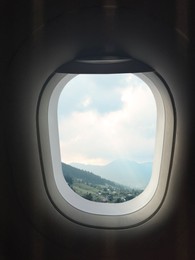 Airplane taking off or landing, view on mountains from window