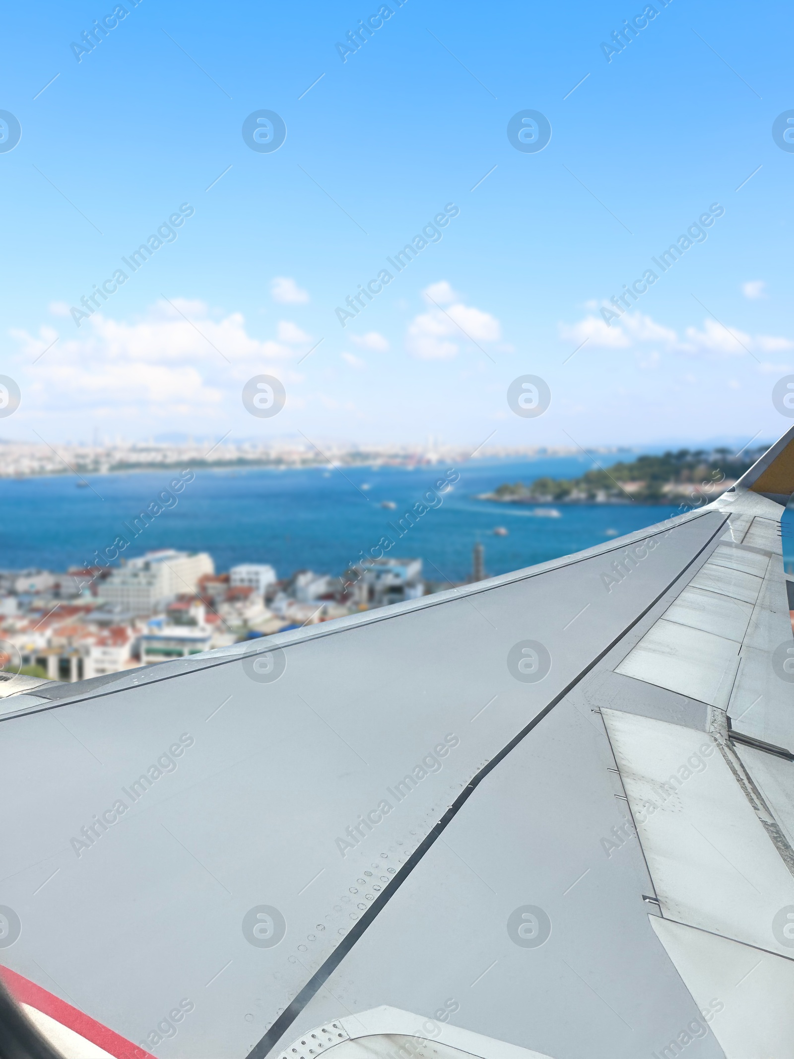 Image of Airplane taking off or landing, view on city from window