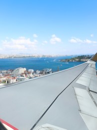 Airplane taking off or landing, view on city from window