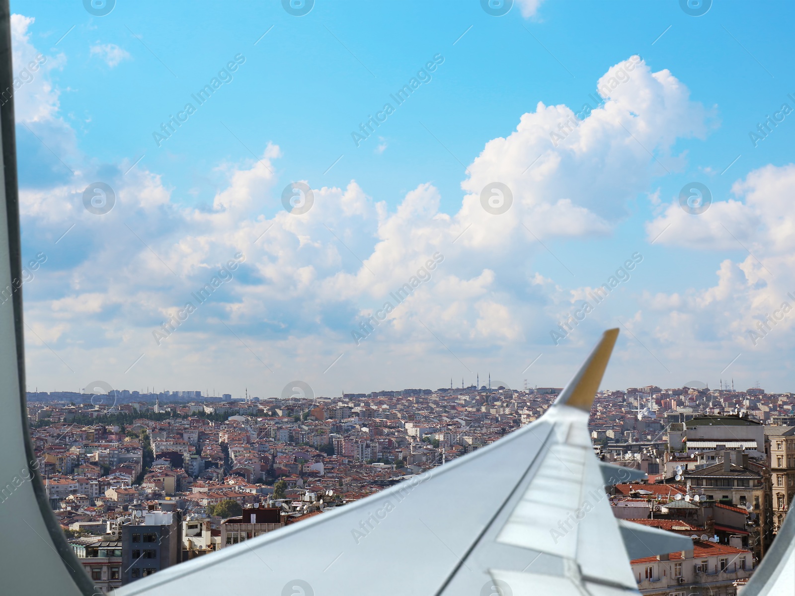 Image of Airplane taking off or landing, view on city from window