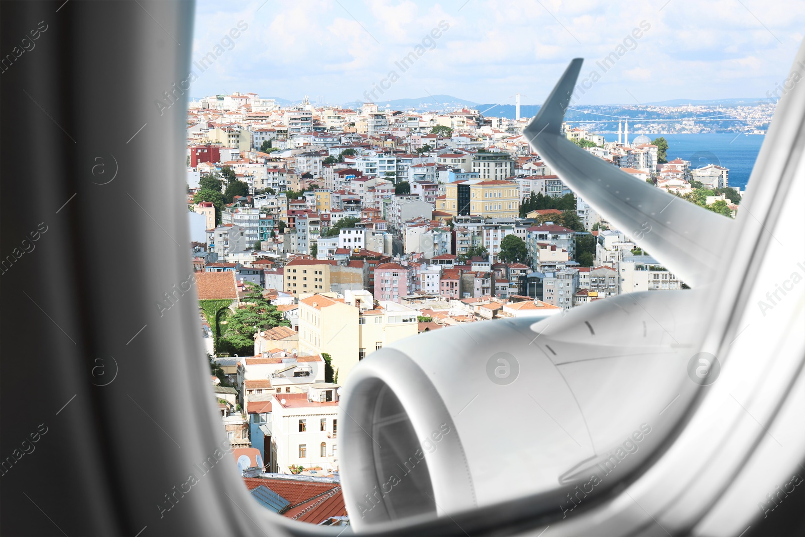 Image of Airplane taking off or landing, view on city from window