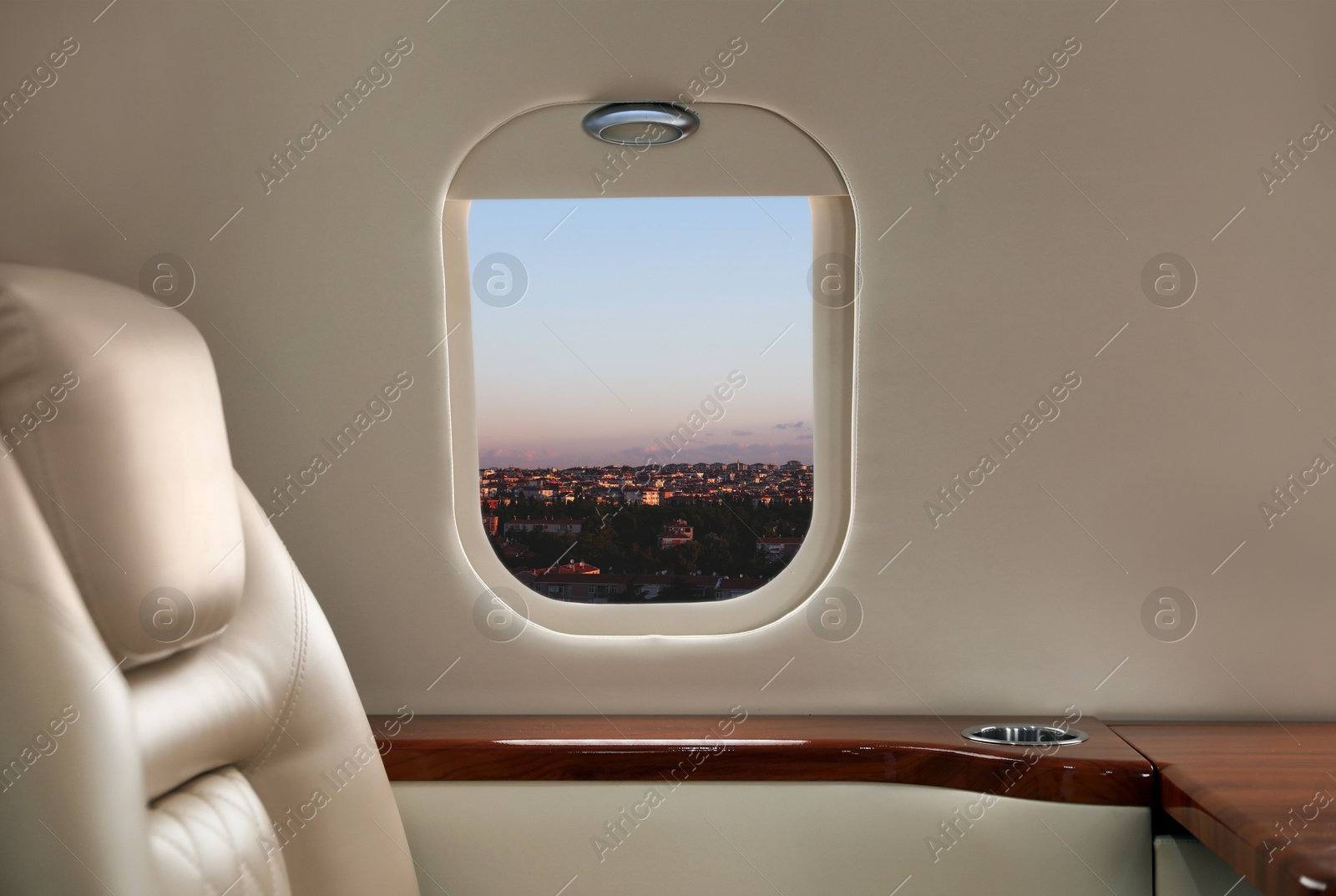 Image of Airplane taking off or landing, view on city from window