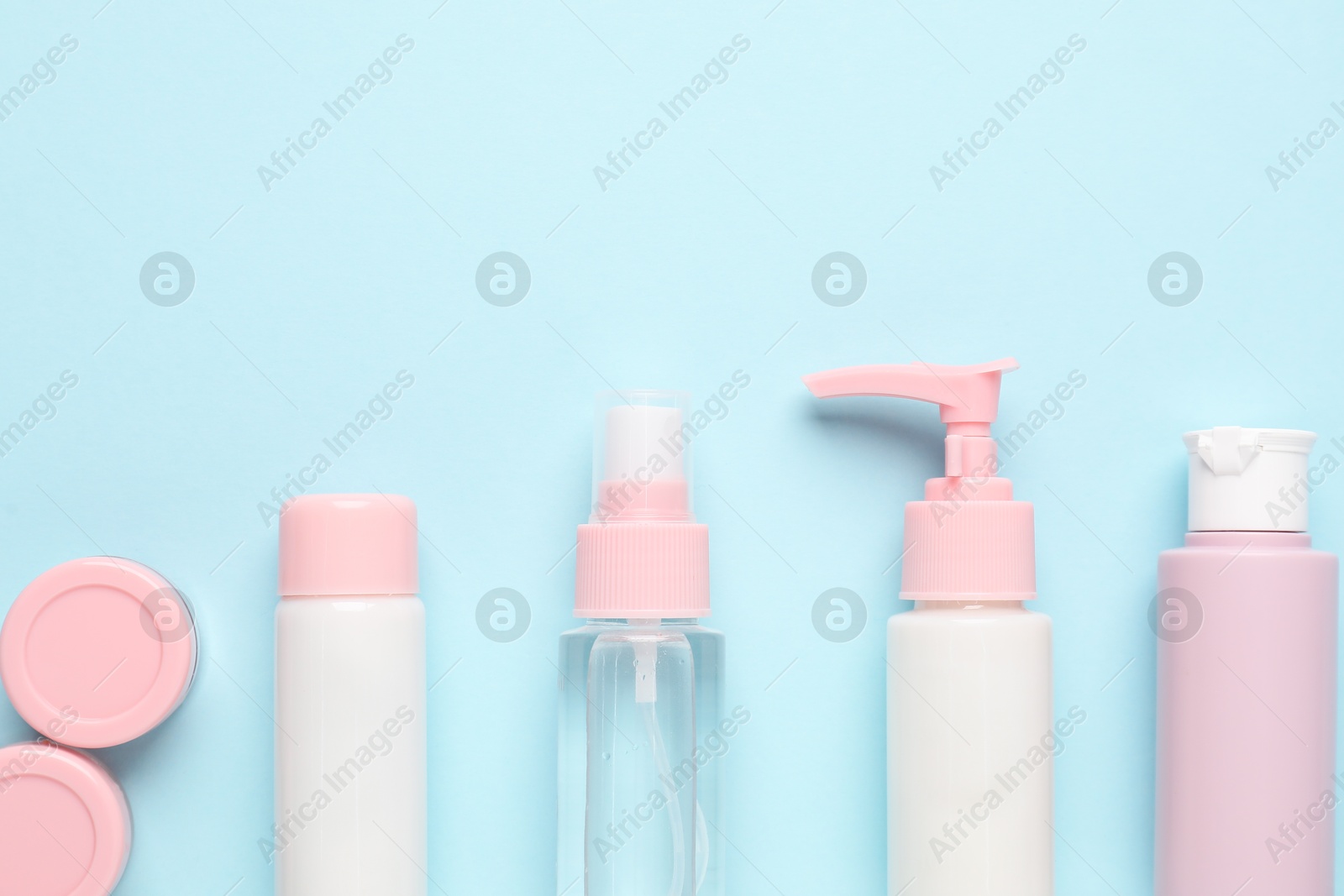 Photo of Different cosmetic products on light blue background, flat lay