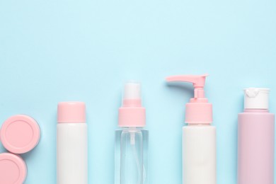 Photo of Different cosmetic products on light blue background, flat lay