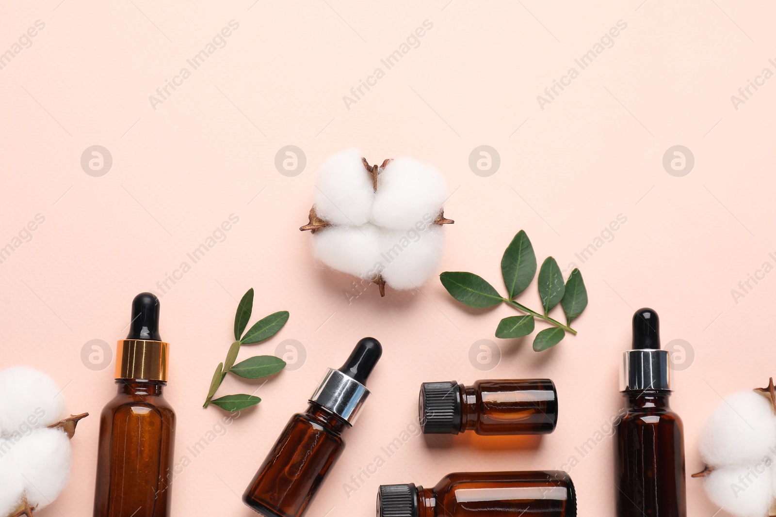 Photo of Different cosmetic products, green leaves and cotton flowers on beige background, flat lay