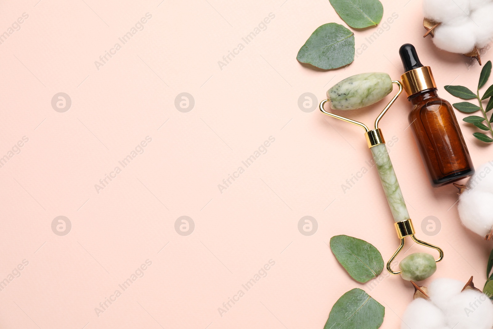 Photo of Different cosmetic products, cotton flowers and green leaves on beige background, flat lay. Space for text