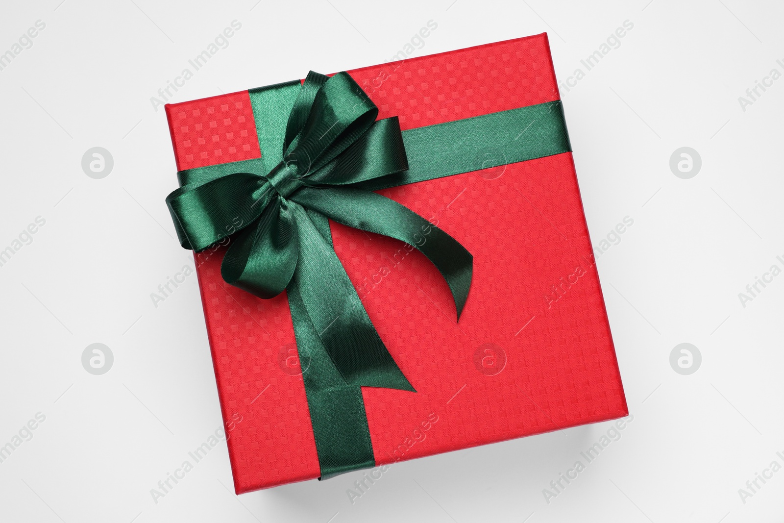 Photo of Gift box with green bow on light grey background, top view