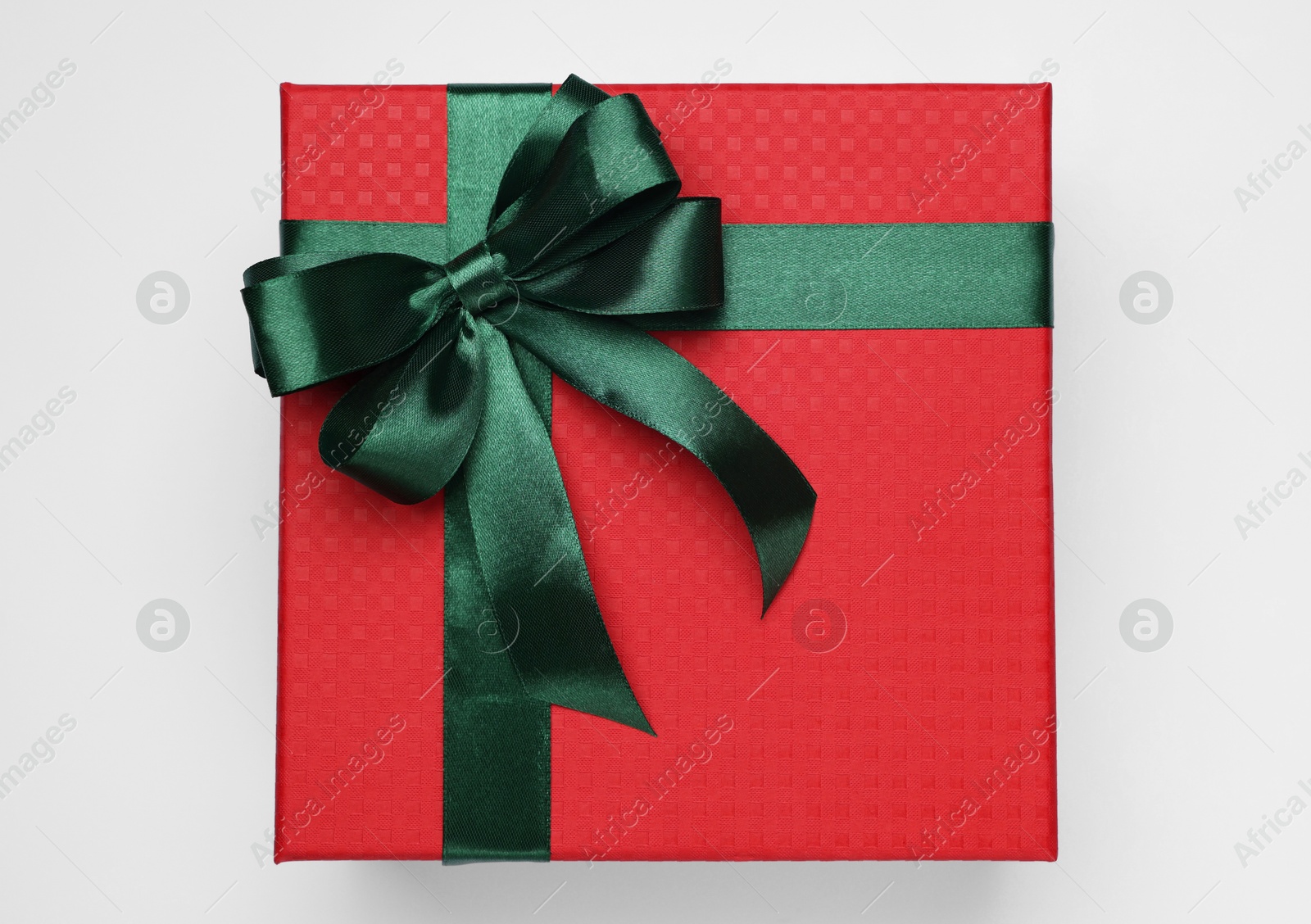 Photo of Gift box with green bow on light grey background, top view