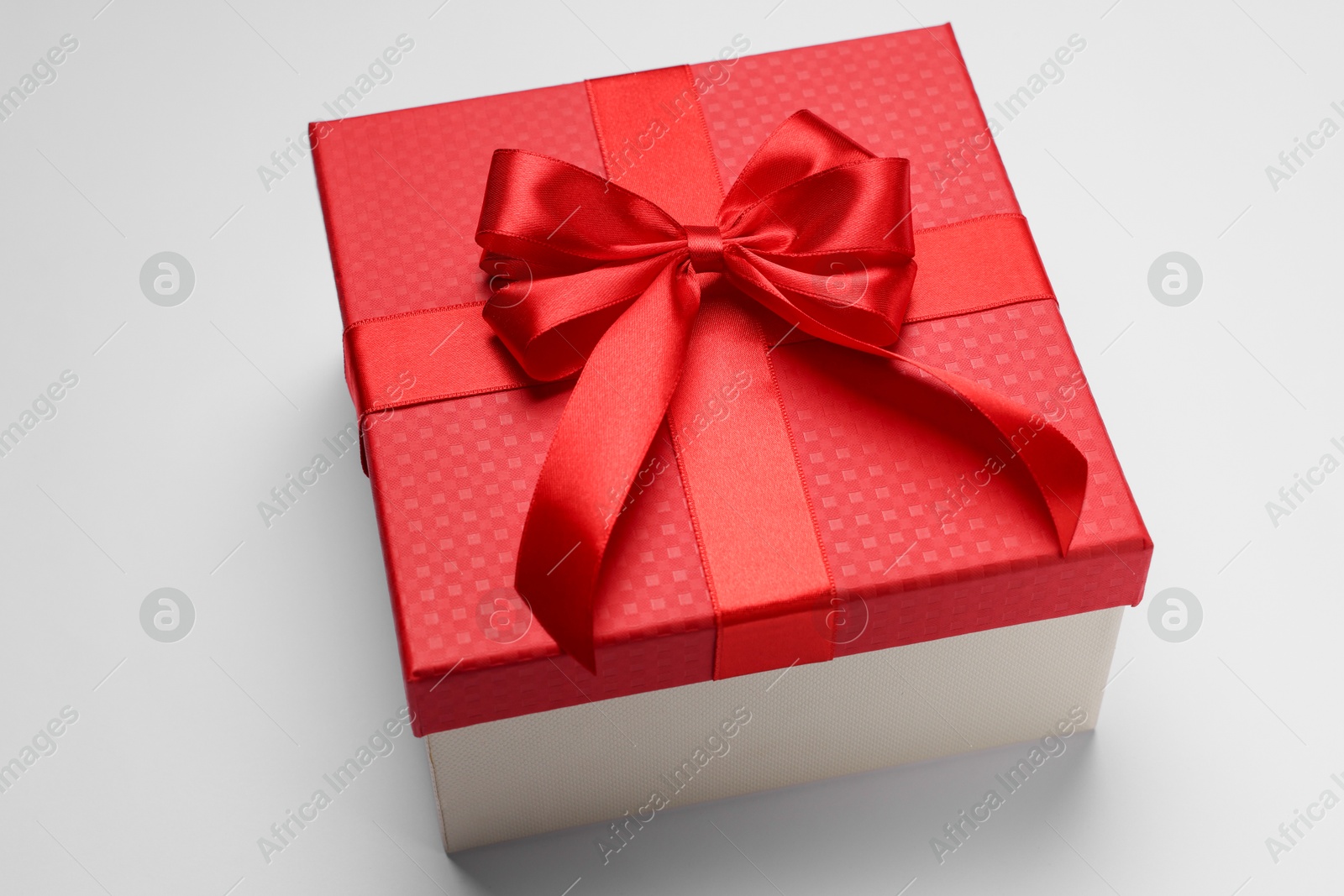 Photo of Gift box with bow on light grey background