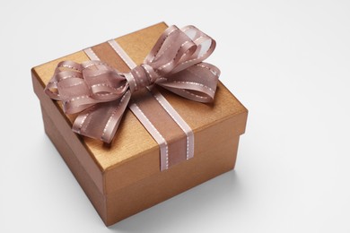 Photo of Gift box with bow on light grey background