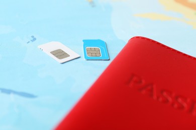 Photo of Passport and SIM cards on world map, closeup