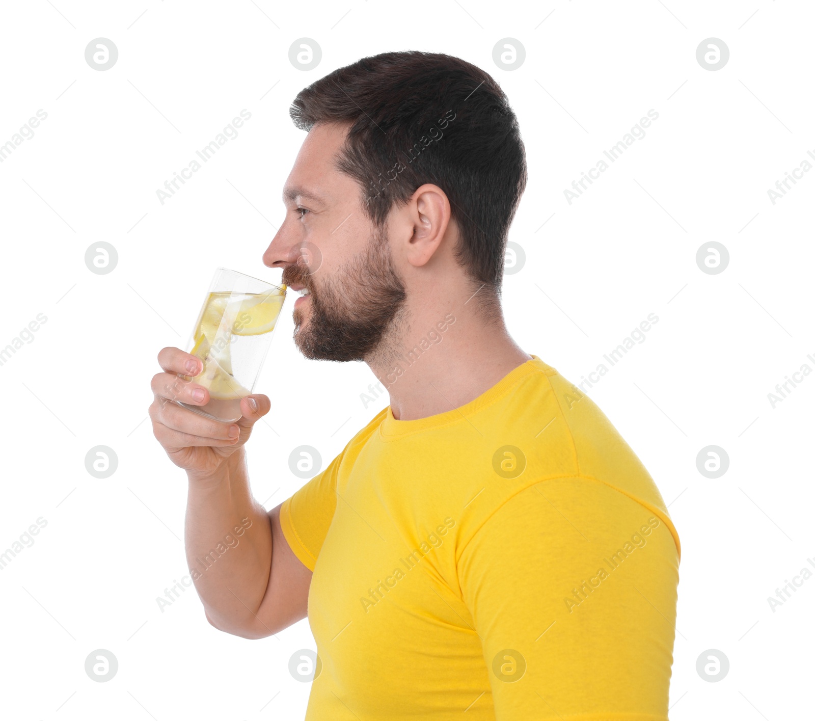 Photo of Handsome man drinking water with lemon on white background