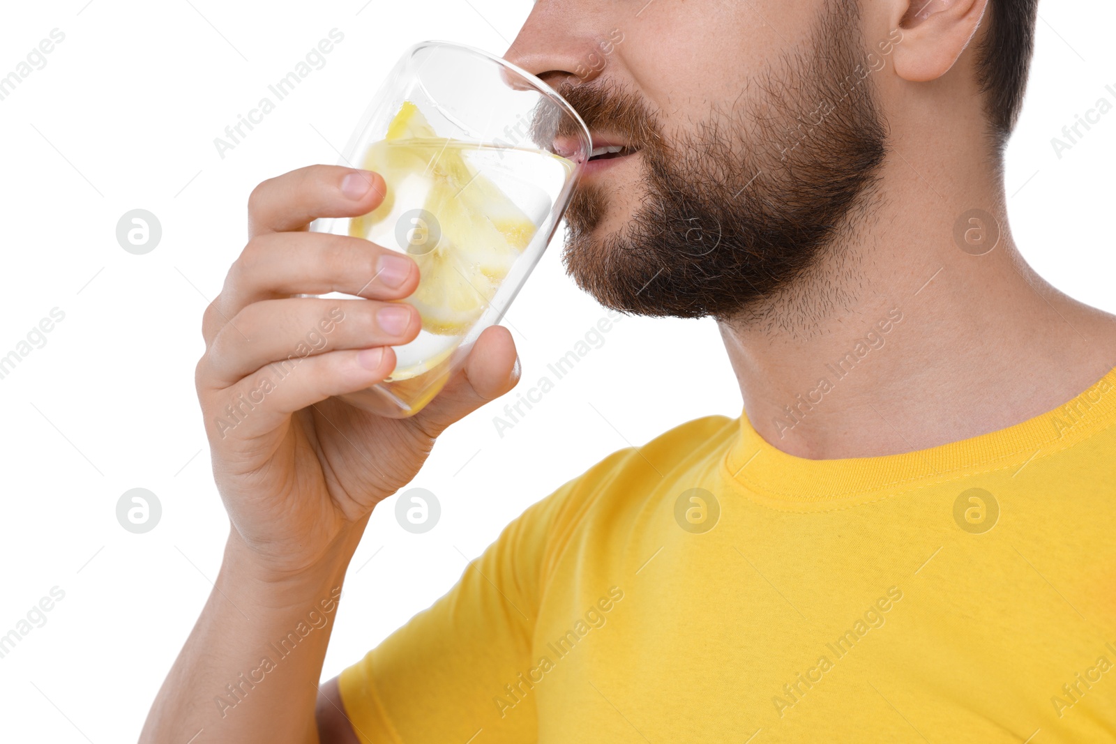 Photo of Man drinking water with lemon on white background, closeup