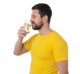 Handsome man drinking water with lemon on white background